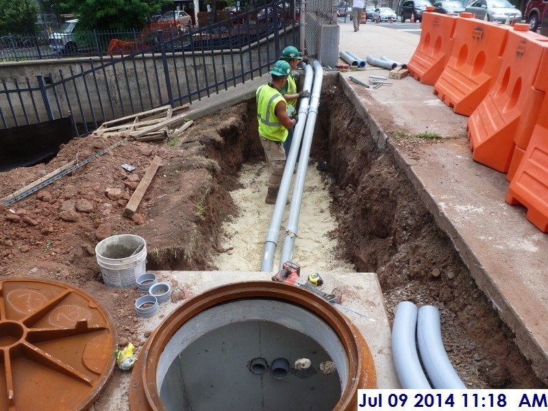 Installing conduit into the manhole Facing the Administration Building (800x600)